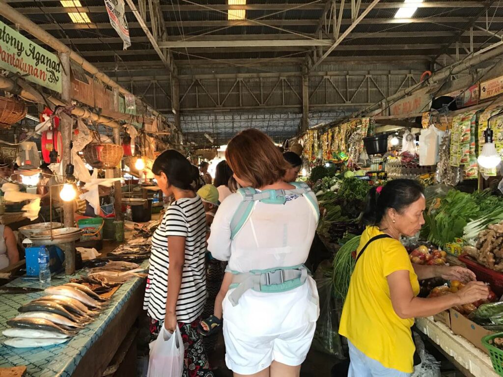 Mother & son looking through the public market in Baler, Aurora.